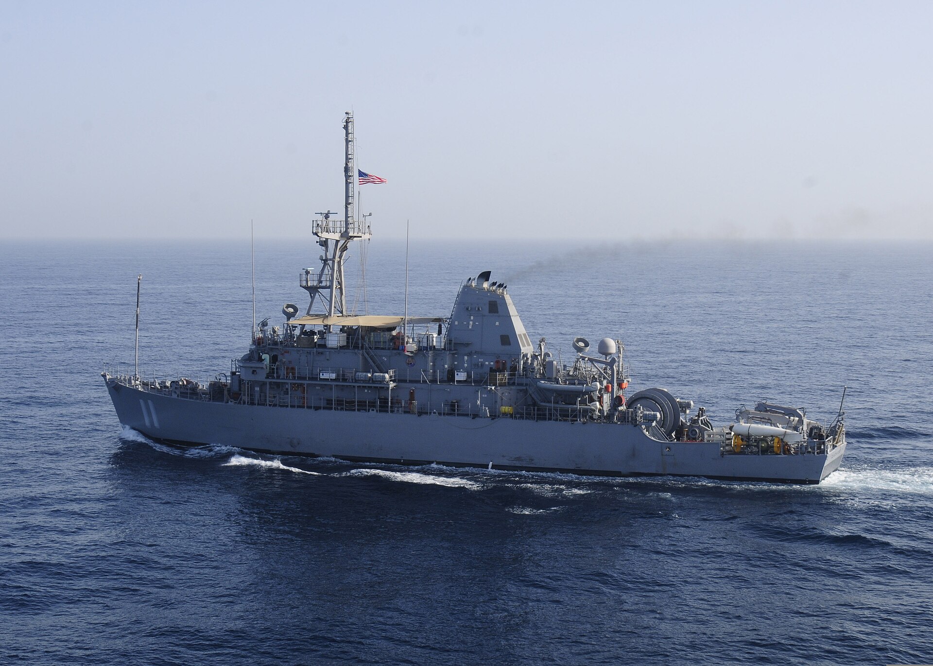 USS Gladiator (MCM-11), an Avenger-class mine countermeasure ship, conducts convoy escort operations in the Persian Gulf during the International Mine Countermeasures Exercise 2013