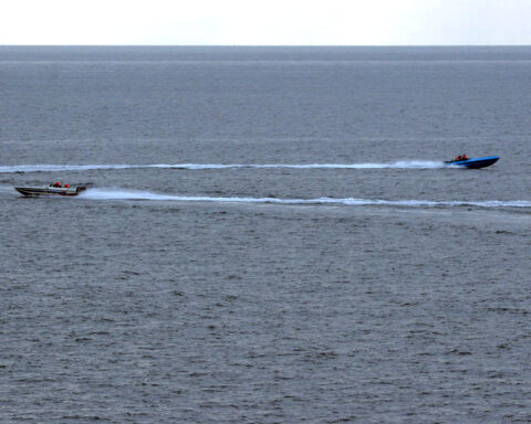 IRGC fast-attack speedboats race at high speed through the Strait of Hormuz, photographed from USS Port Royal during a January 2008 confrontation.