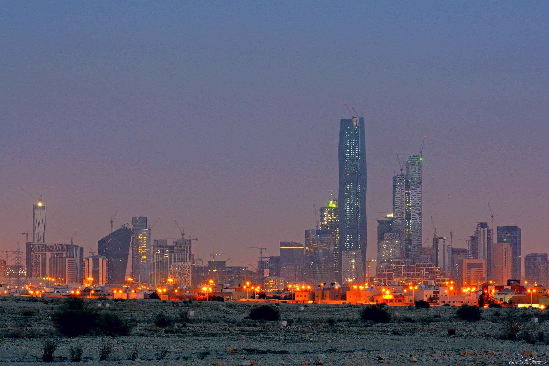 King Abdullah Financial District, Riyadh, at dusk, viewed from the northeast — KAFD is home to the Public Investment Fund tower and the financial infrastructure FII promotes to global investors