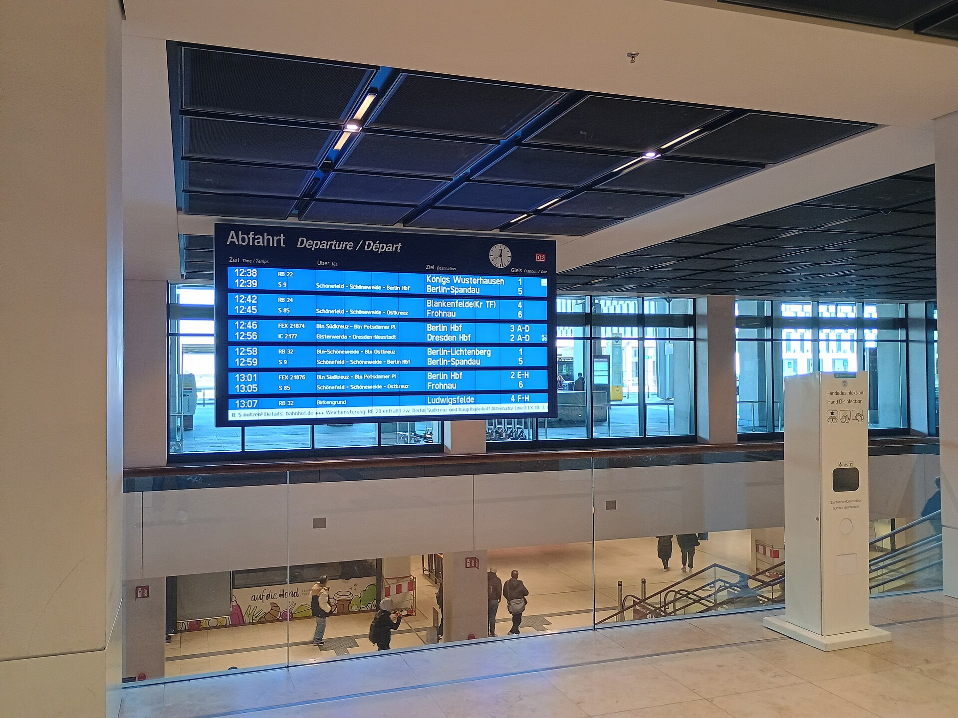 Empty airport terminal departure hall with flight information board, illustrating aviation disruption and flight cancellations