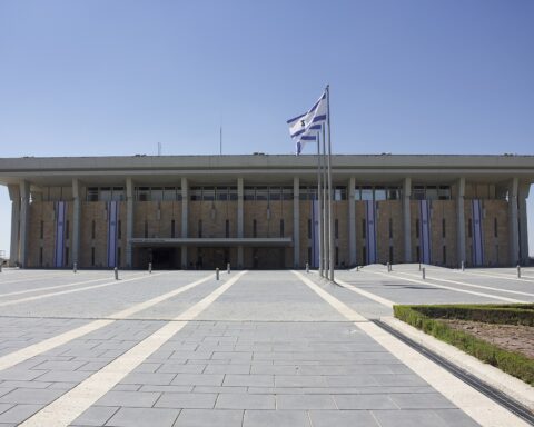 The Knesset, Israel's parliament, with Israeli flags flying from the facade, Jerusalem