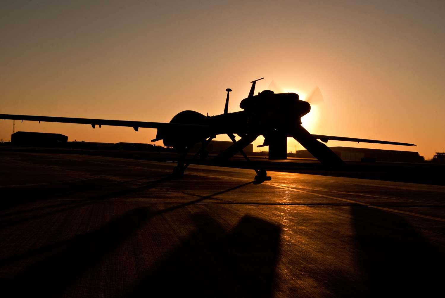 MQ-1C Gray Eagle drone silhouetted at sunrise at Camp Taji, Iraq — the Army surveillance platform at the center of the Iran drone shootdown dispute. Photo: US Army / Public Domain