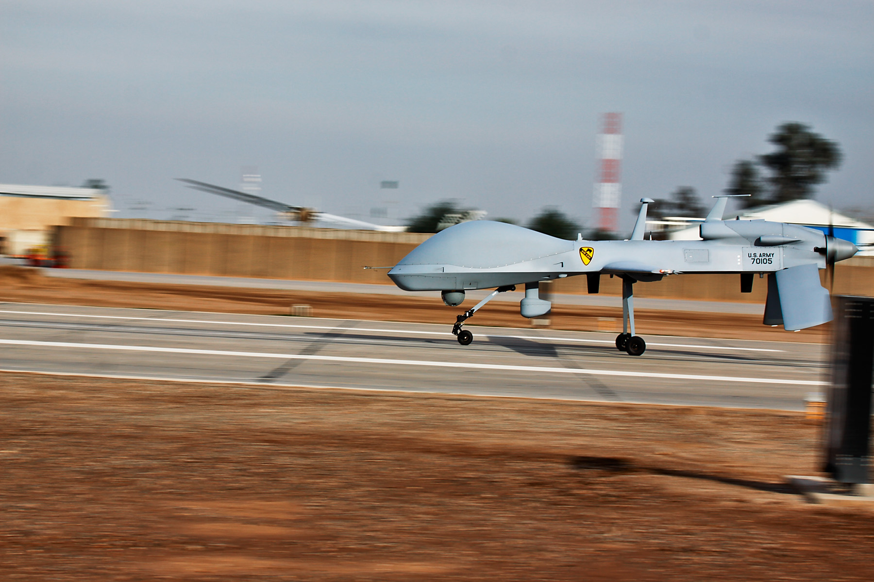 A US Army MQ-1C Sky Warrior lands after completing a 24-hour surveillance mission — the endurance capability that makes Gray Eagles the primary ISR platform over the Strait of Hormuz. Photo: US Army / Public Domain