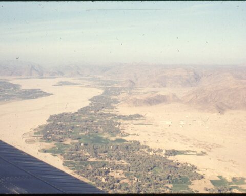 Aerial view of Najran city sitting in its wadi, southern Saudi Arabia, with desert mountains visible on the horizon