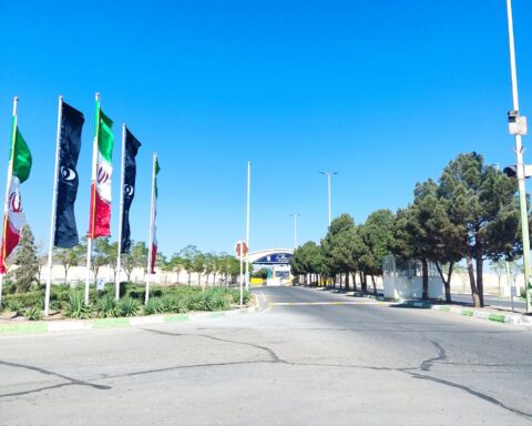 Entrance gate to Iran's Natanz uranium enrichment facility with AEOI atomic symbol flags, Iran