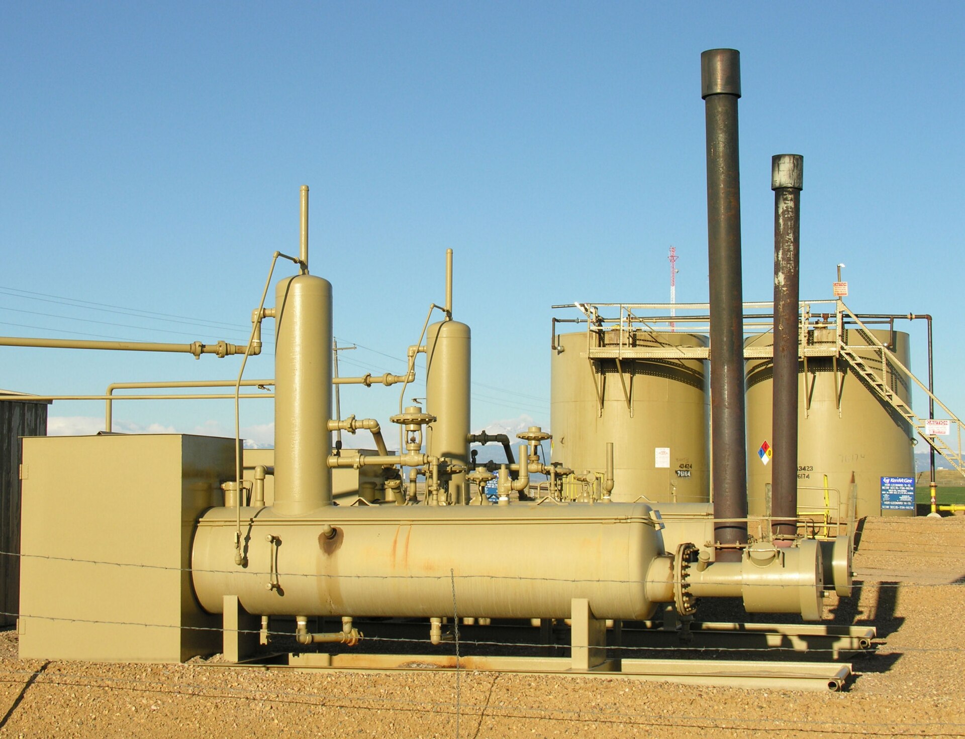 An oil pipeline pumping station with pressurisation vessels, storage tanks and flare stacks, representative of the 13 booster stations along the 1,200-kilometre Petroline route