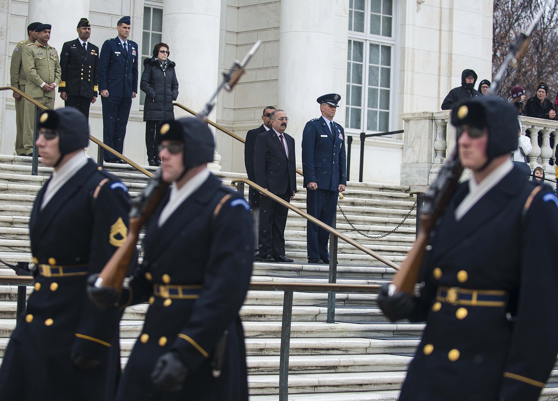 Pakistani Defense Minister Khawaja Asif reviews troops at Arlington National Cemetery during US-Pakistan defense meeting 2014 illustrating the bilateral military relationship that underpins the Mecca Pact deployment
