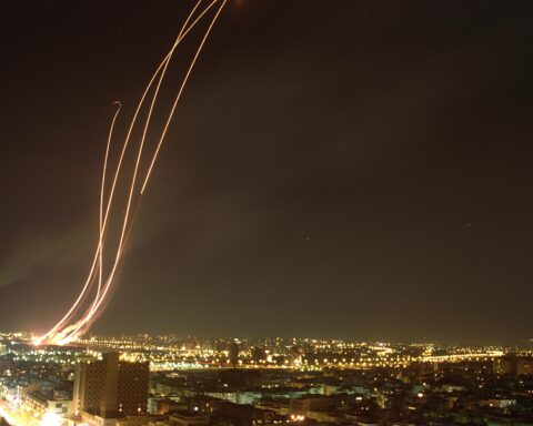 Patriot missiles launched from Riyadh to intercept Iraqi Scud ballistic missiles, 1991 Gulf War, night photo showing multiple missile trails over city lights