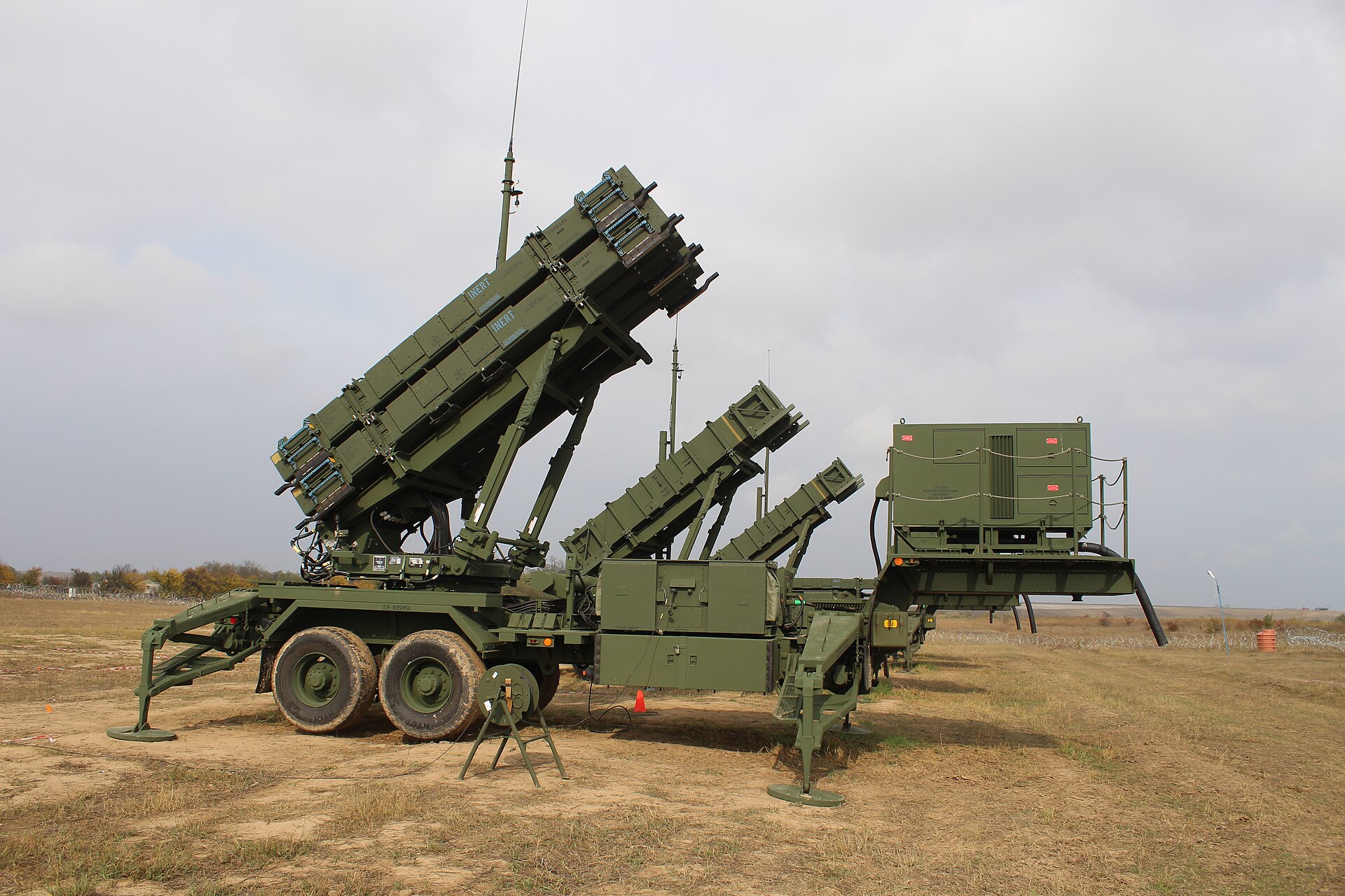 Patriot PAC-3 surface-to-air missile battery with launchers elevated and ready, deployed for air defense