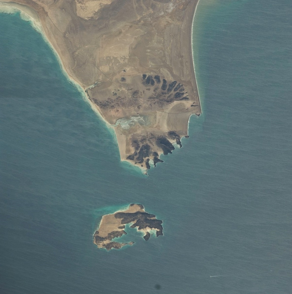 NASA aerial photograph of Perim Island (Mayyun) at the narrowest point of the Bab el-Mandeb strait, with the Shaikh Said Peninsula of Yemen above