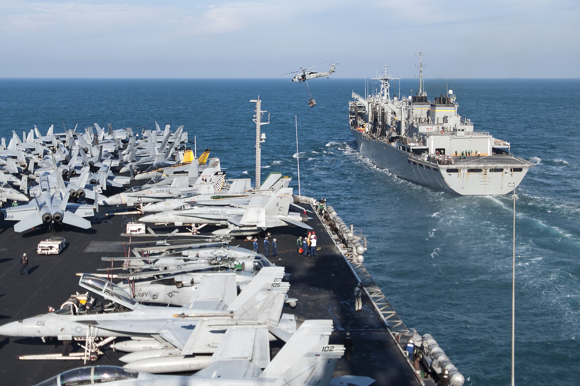 USS Harry S. Truman aircraft carrier receives cargo via MH-60S helicopter from USNS Arctic during replenishment at sea in the Persian Gulf, January 2014