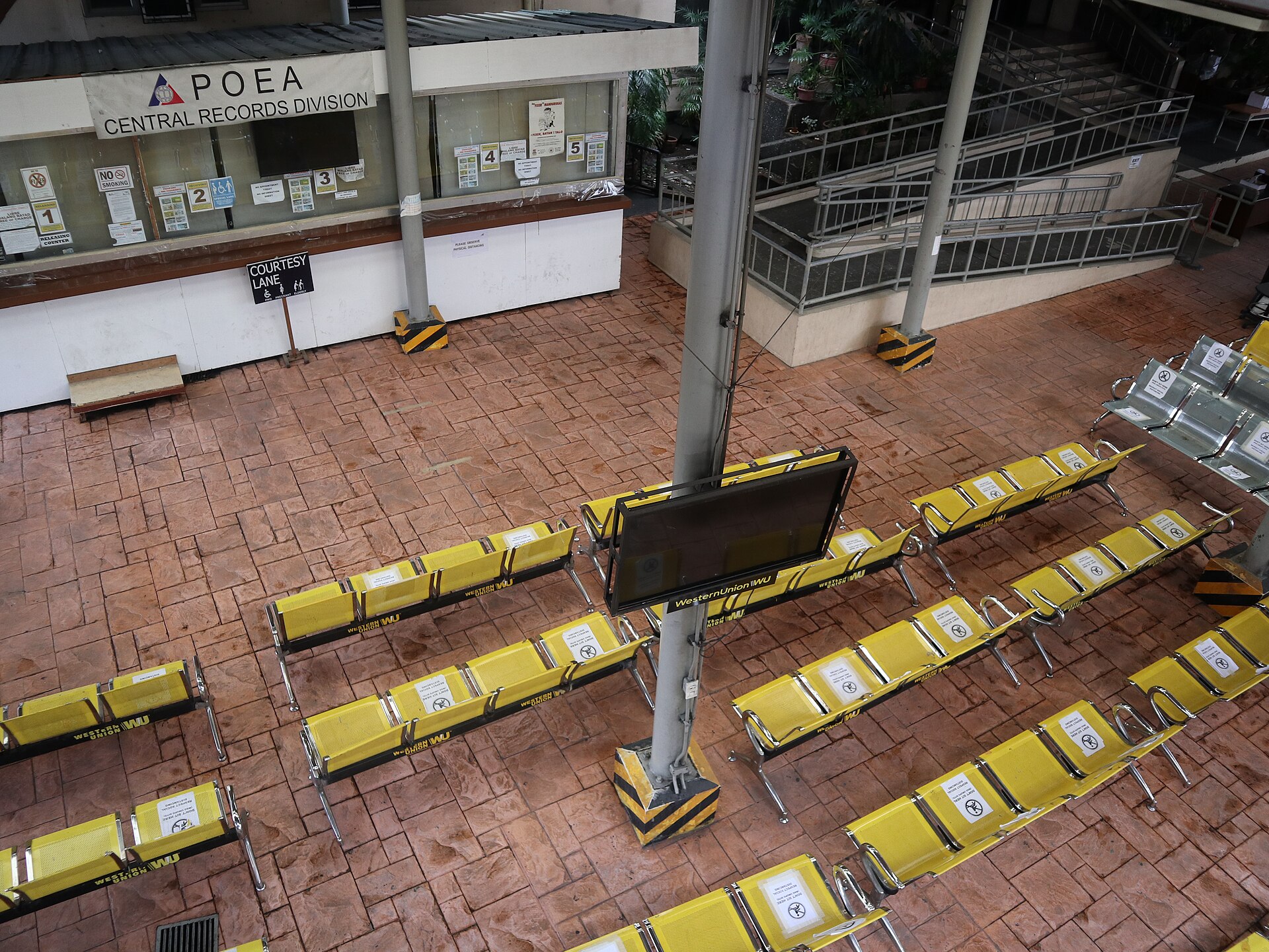 POEA Central Records Division waiting hall in the Blas F. Ople Building, EDSA-Ortigas Avenue, Mandaluyong — the bureaucratic processing centre for overseas Filipino worker deployment