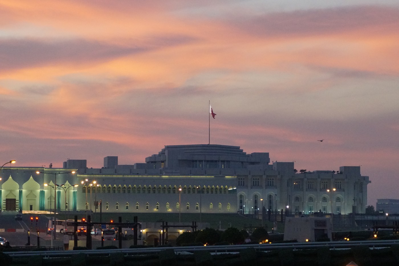 Qatar Amiri Diwan at dusk with Qatar flag, Doha — seat of the emirate that delivered two draft proposals to Tehran in five days