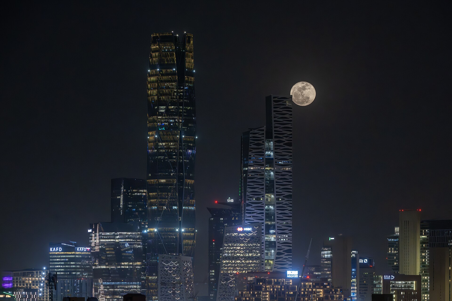 Riyadh King Abdullah Financial District KAFD skyline at night with full moon, 2026
