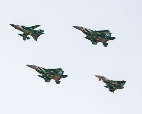Royal Saudi Air Force F-15 and Eurofighter Typhoon jets in special Saudi national livery flying in formation, representing the RSAF air power behind the Yemen coalition campaign
