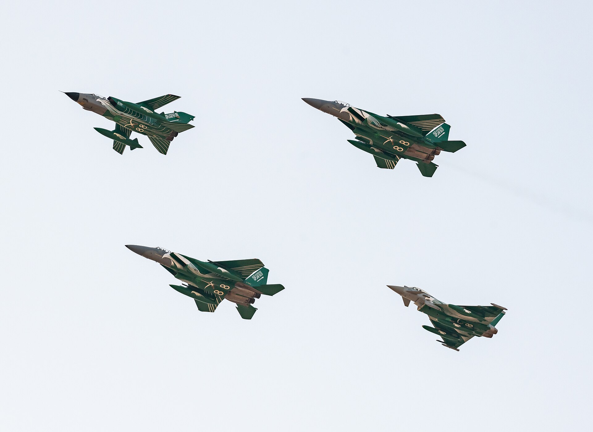 Royal Saudi Air Force F-15 and Eurofighter Typhoon jets in special Saudi national livery flying in formation, representing the RSAF air power behind the Yemen coalition campaign