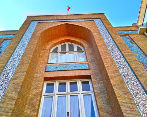 Iran Ministry of Foreign Affairs building in Tehran, ornate brick facade with Persian tilework and Iranian flag