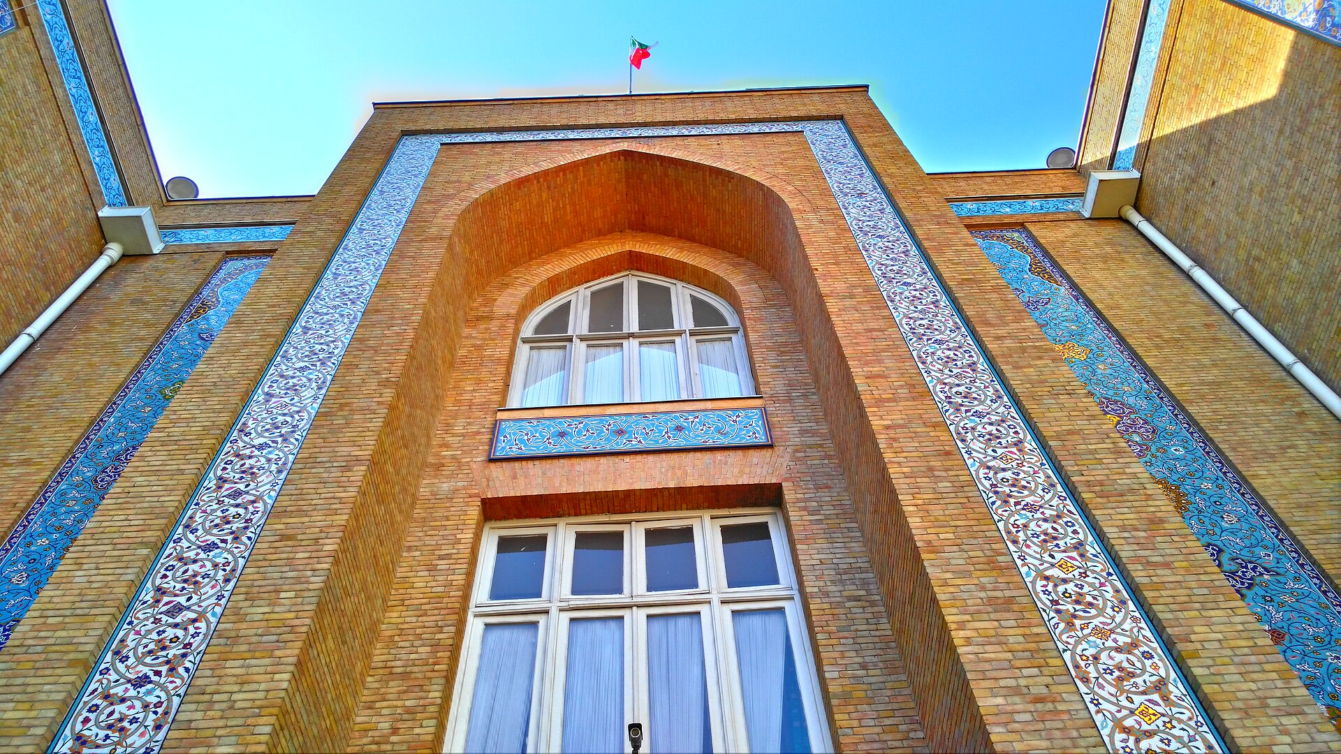 Iran Ministry of Foreign Affairs building in Tehran, ornate brick facade with Persian tilework and Iranian flag