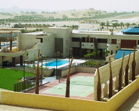 US Embassy compound in Riyadh, Saudi Arabia, showing the mission residence building, pool, tennis court and compound walls, photographed circa 1990
