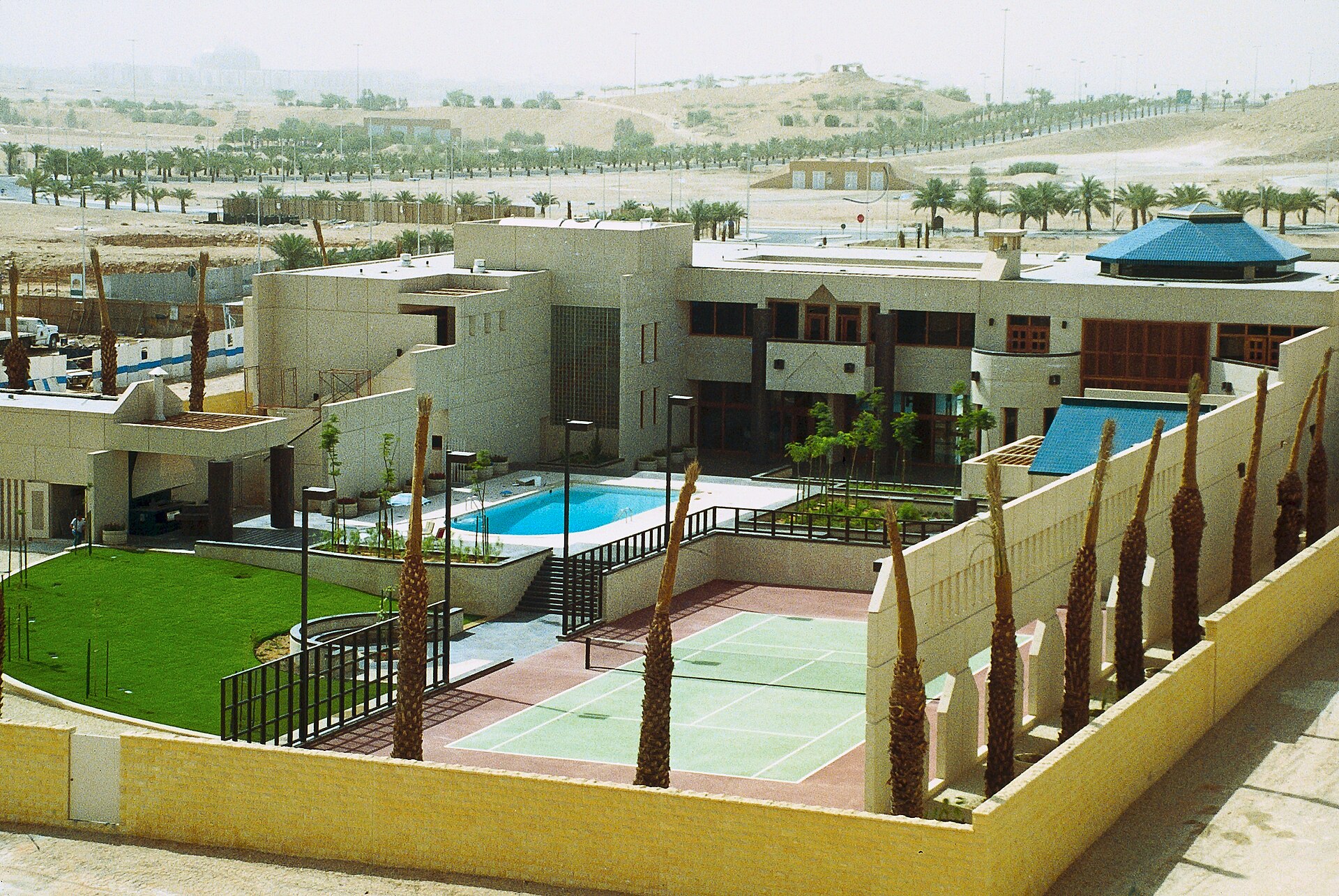 US Embassy compound in Riyadh, Saudi Arabia, showing the mission residence building, pool, tennis court and compound walls, photographed circa 1990