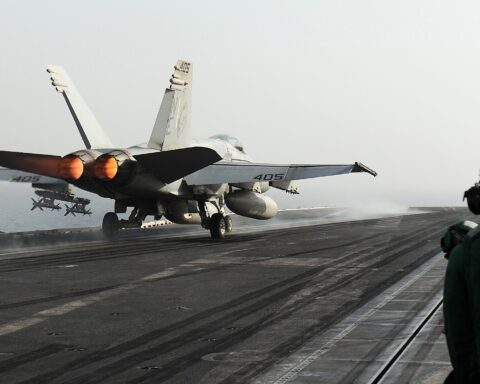 An F/A-18C Hornet on afterburner launches from the flight deck of USS Abraham Lincoln (CVN 72) in the Arabian Gulf, June 2012, during a deployment to the US 5th Fleet area of responsibility
