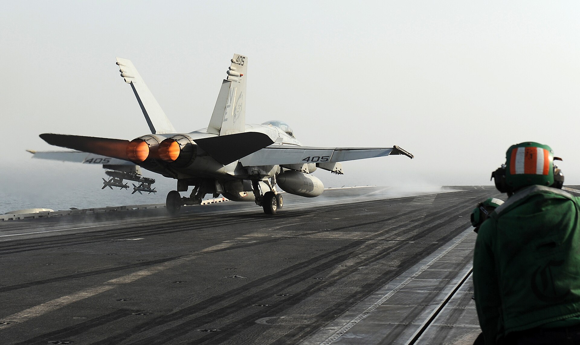 An F/A-18C Hornet on afterburner launches from the flight deck of USS Abraham Lincoln (CVN 72) in the Arabian Gulf, June 2012, during a deployment to the US 5th Fleet area of responsibility