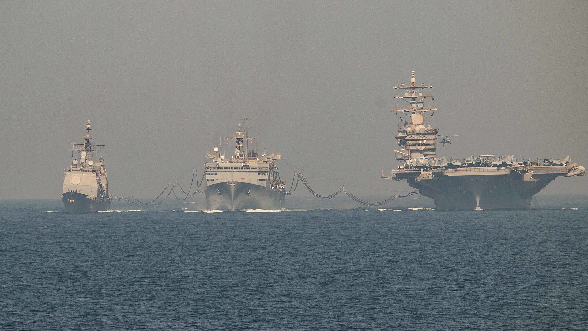 USS Dwight D. Eisenhower carrier strike group and USS San Jacinto refuel from USNS Arctic in the Arabian Gulf