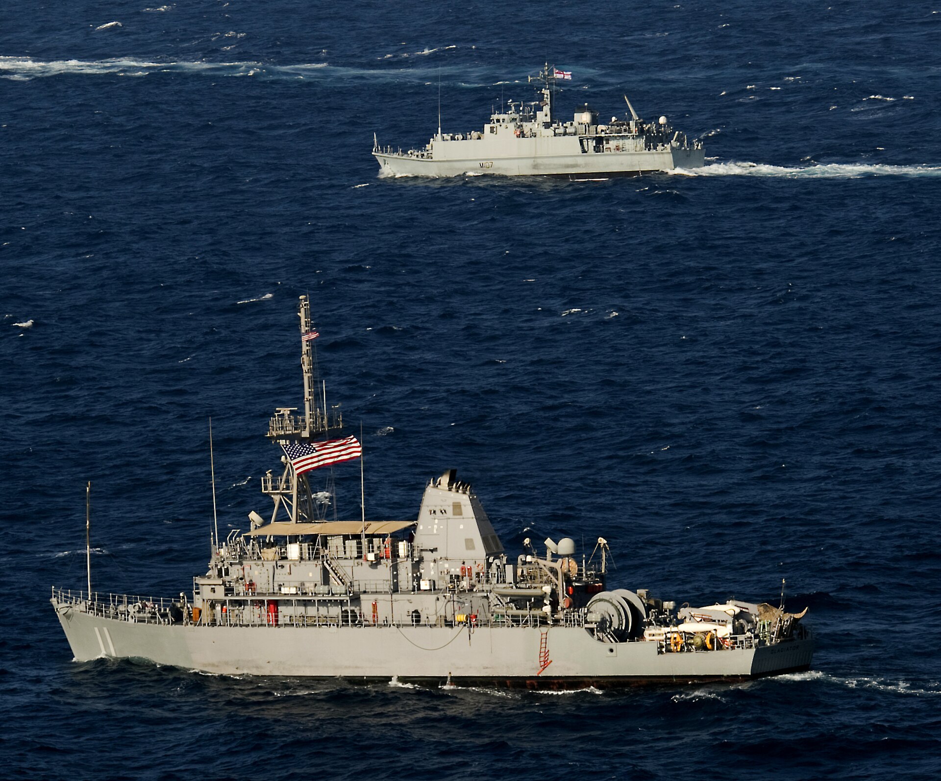 USS Gladiator MCM 11 and HMS Pembroke M107 mine countermeasures ships in formation in the Arabian Gulf