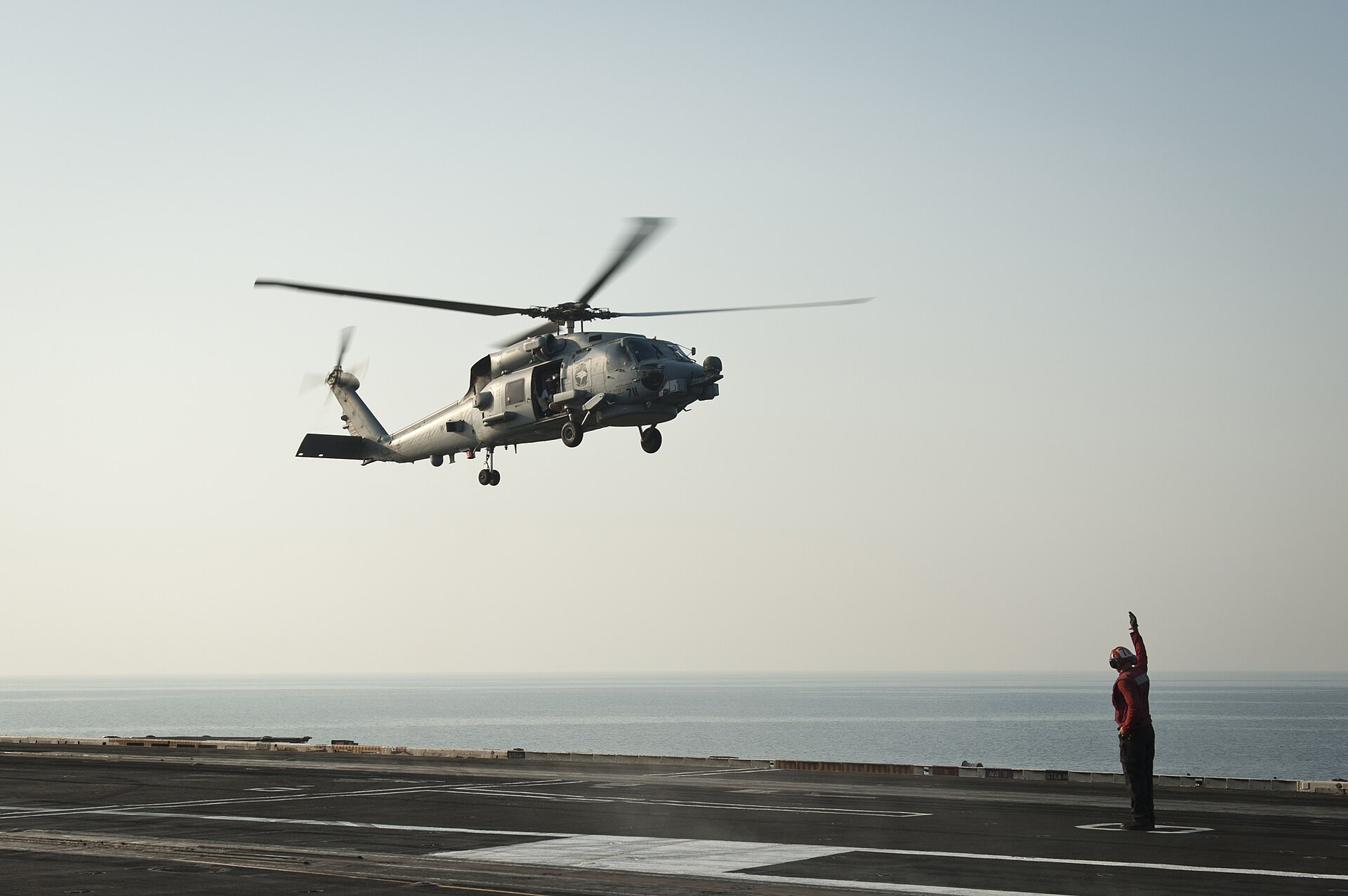 An MH-60R Sea Hawk helicopter from Helicopter Maritime Strike Squadron 75 prepares to land on the flight deck of USS Nimitz (CVN 68) in the Arabian Gulf, August 2013, during a Fifth Fleet deployment